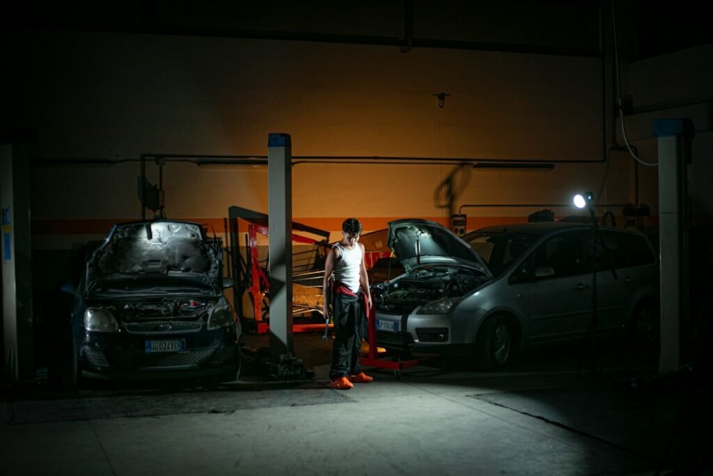Automotive technician diagnosing a vehicle in a professional repair workshop