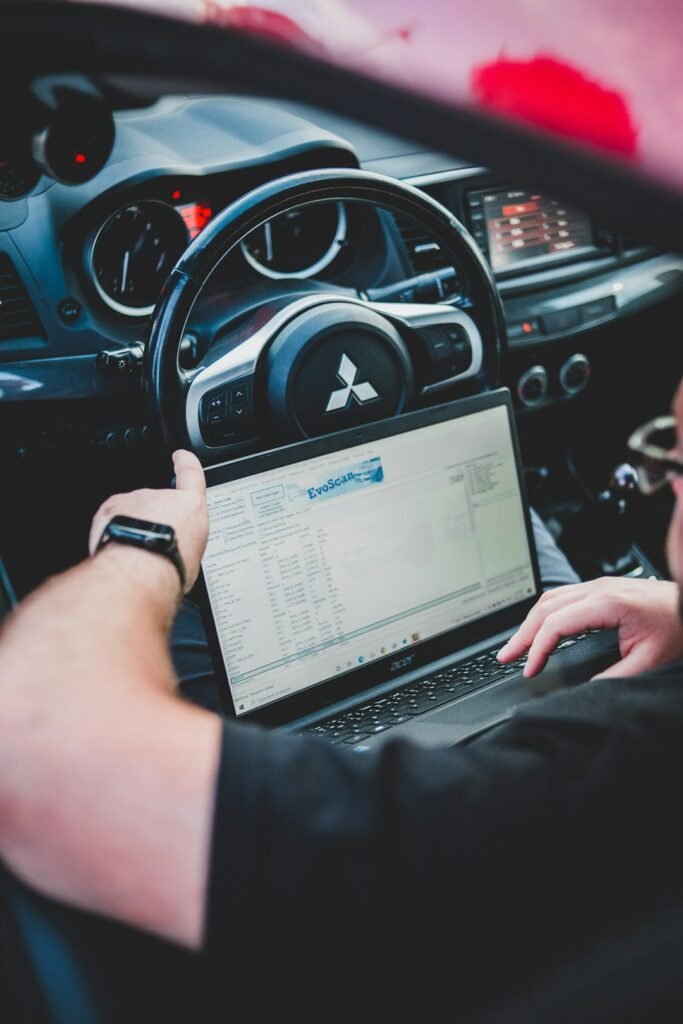 Mechanic checking car diagnostic scan cost estimate in Dhaka