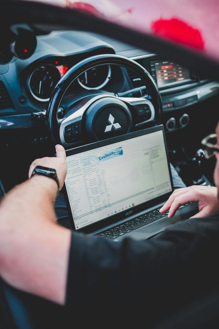 Mechanic checking car diagnostic scan cost estimate in Dhaka