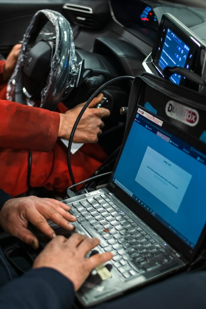 Technician running a European car diagnostic scan in Dhaka