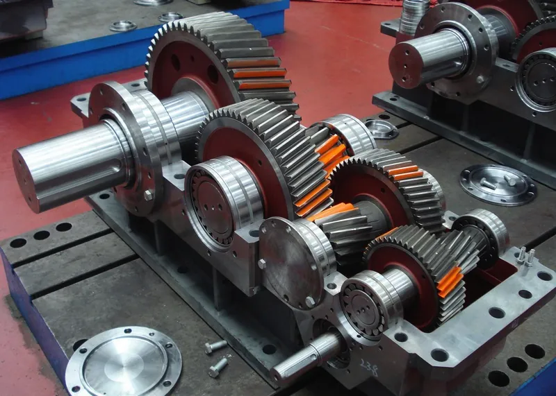 Rebuilt gearbox and complete replacement unit displayed side by side on a pallet.